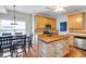 Sunlit kitchen with stainless appliances, butcher block island, wood floors, and adjoining dining area at 10 Bayberry Ct, Acworth, GA 30101