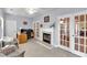 Cozy sunroom with a fireplace, tile floor, and access to the outside through glass paneled doors at 10 Bayberry Ct, Acworth, GA 30101