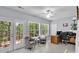 Bright sunroom featuring large windows, a ceiling fan, and patio doors leading to an outdoor deck at 10 Bayberry Ct, Acworth, GA 30101