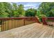 Wooden back deck with stained wooden rails overlooking a green backyard at 2821 Highway 11, Mansfield, GA 30055