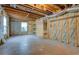 Unfinished basement area with exposed ceiling, walls and shelving; ready for your custom design at 2821 Highway 11, Mansfield, GA 30055