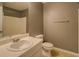Bathroom featuring a single sink vanity, toilet, shower-tub and gray walls at 2821 Highway 11, Mansfield, GA 30055