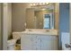 Bathroom featuring a dual sink vanity, commode, large mirror, and view of another bathroom at 2821 Highway 11, Mansfield, GA 30055