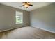Bedroom featuring neutral carpet, natural light from a window, and a ceiling fan for added comfort at 2821 Highway 11, Mansfield, GA 30055