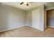 A bedroom featuring a ceiling fan, plush carpet, white door and a bright window at 2821 Highway 11, Mansfield, GA 30055