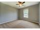 A bedroom featuring a ceiling fan, plush carpet and a bright window at 2821 Highway 11, Mansfield, GA 30055