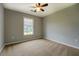 A bedroom featuring a ceiling fan, plush carpet and a bright window at 2821 Highway 11, Mansfield, GA 30055