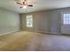 A bonus room with neutral carpet, a window for natural light, and a door leading to the exterior at 2821 Highway 11, Mansfield, GA 30055