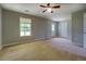 Neutral bonus room includes neutral walls and carpet, multiple doors, and a window for natural light at 2821 Highway 11, Mansfield, GA 30055
