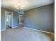 Bright dining room featuring neutral carpeting, gray walls, and a decorative chandelier at 2821 Highway 11, Mansfield, GA 30055