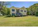 Charming two-story home with a well-manicured lawn and mature trees surrounding the property at 2821 Highway 11, Mansfield, GA 30055