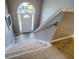 Bright foyer with a staircase, carpet runner and a view of the front door at 2821 Highway 11, Mansfield, GA 30055