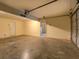 Unfinished garage with concrete floor, garage door and a standard entry door at 2821 Highway 11, Mansfield, GA 30055