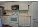 Fully equipped kitchen with bright white cabinets and modern appliances at 2821 Highway 11, Mansfield, GA 30055