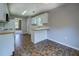 Well-lit kitchen showcasing tile floor, white cabinets, and a view into the dining room at 2821 Highway 11, Mansfield, GA 30055