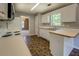 Spacious kitchen with white appliances, white cabinets, and a view into the dining room at 2821 Highway 11, Mansfield, GA 30055