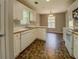 Open kitchen showcasing white appliances, tile floor, and wood trim countertops at 2821 Highway 11, Mansfield, GA 30055