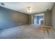 Large living room featuring neutral walls and carpet, with an open doorway to the foyer at 2821 Highway 11, Mansfield, GA 30055