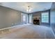 Spacious living room featuring neutral carpeting and a stone fireplace at 2821 Highway 11, Mansfield, GA 30055