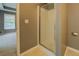 Shower with clear glass doors next to a window and beige tiled floor at 2821 Highway 11, Mansfield, GA 30055