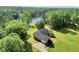 Aerial view of a well-maintained home with mature trees, sprawling lawn, and lake access at 70 Lake Charles Xing, Covington, GA 30016