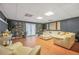Large basement is perfect for entertaining, featuring plush seating and stylish decor at 70 Lake Charles Xing, Covington, GA 30016