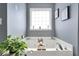 Bright bathroom featuring a soaking tub, and a window providing natural light at 70 Lake Charles Xing, Covington, GA 30016