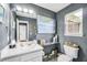Tastefully decorated half bath with a modern sink, vanity, decorative art, and complementary paint. Has window at 70 Lake Charles Xing, Covington, GA 30016