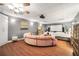 A comfortable bedroom includes a half-moon sofa, a screen projector, and hardwood floors at 70 Lake Charles Xing, Covington, GA 30016