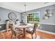 Charming dining room with hardwood floors, modern lighting, and a scenic view of the outdoors at 70 Lake Charles Xing, Covington, GA 30016
