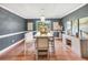 Elegant dining room with wood floors, decorative lighting, and modern decor. Window provides views to landscaped outdoor area at 70 Lake Charles Xing, Covington, GA 30016