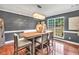 Chic dining area with hardwood floors, gray walls, stylish lighting, and large window overlooking the manicured outdoors at 70 Lake Charles Xing, Covington, GA 30016