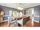 Sophisticated dining room with hardwood floors, elegant lighting fixture, modern wall art, decor, and bench seating at 70 Lake Charles Xing, Covington, GA 30016