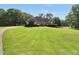 Beautiful lakeside home surrounded by a vast, well-manicured lawn and mature trees at 70 Lake Charles Xing, Covington, GA 30016