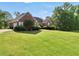Traditional brick home with an expansive lawn and established landscaping at 70 Lake Charles Xing, Covington, GA 30016