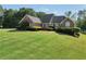 Charming brick house with manicured landscaping and a large green lawn at 70 Lake Charles Xing, Covington, GA 30016