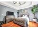 Inviting bedroom with hardwood floors, a large window, soft, neutral decor, and a ceiling fan at 70 Lake Charles Xing, Covington, GA 30016