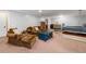 Finished basement area with sofa, daybed, and dark-blue accent pieces at 164 Stoneforest Dr, Woodstock, GA 30189