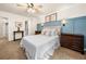 Bedroom with a decorative blue accent wall, neutral walls, carpet flooring, a window, and a ceiling fan at 164 Stoneforest Dr, Woodstock, GA 30189