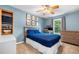 Bedroom features a ceiling fan, natural light, and desk with computer at 164 Stoneforest Dr, Woodstock, GA 30189