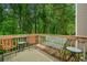 Inviting deck space with comfortable chairs and tables, perfect for outdoor relaxation at 164 Stoneforest Dr, Woodstock, GA 30189
