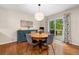 Cozy dining area with hardwood floors, a round table, and sliding glass doors to the backyard at 164 Stoneforest Dr, Woodstock, GA 30189
