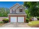 Charming home with a two-car garage, brick accents, neutral siding, and well-maintained landscaping at 164 Stoneforest Dr, Woodstock, GA 30189