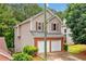 Beautiful home exterior with two-car garage, brick facade, and lush green surroundings at 164 Stoneforest Dr, Woodstock, GA 30189