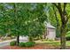 Charming home exterior featuring a well-manicured lawn and lush greenery, creating a welcoming curb appeal at 164 Stoneforest Dr, Woodstock, GA 30189