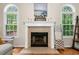 Close-up of a fireplace with white mantel, tile surround, and hardwood floors at 164 Stoneforest Dr, Woodstock, GA 30189