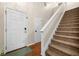 Inviting foyer featuring hardwood floors, a staircase with white railing, and a front door at 164 Stoneforest Dr, Woodstock, GA 30189