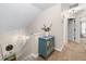 Upstairs hallway with neutral decor, a display cabinet, and access to bedrooms at 164 Stoneforest Dr, Woodstock, GA 30189