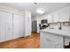 Modern kitchen with stainless steel appliances, white cabinets, and white countertops with ample storage at 164 Stoneforest Dr, Woodstock, GA 30189