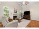 Cozy living room featuring a fireplace, hardwood floors, and a comfortable seating area at 164 Stoneforest Dr, Woodstock, GA 30189